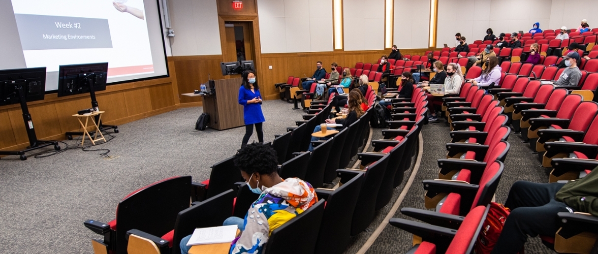 professor teaching students in large auditorium